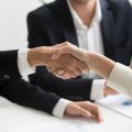 Female hands shaking at group meeting making partnership deal, businesswoman welcoming new partner with handshake as concept of collaboration gratitude respect, women power in business, close up view